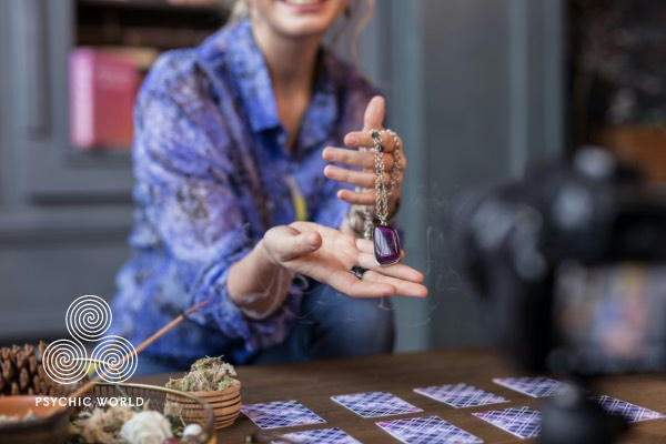 woman holding a crystal to read tarot cards