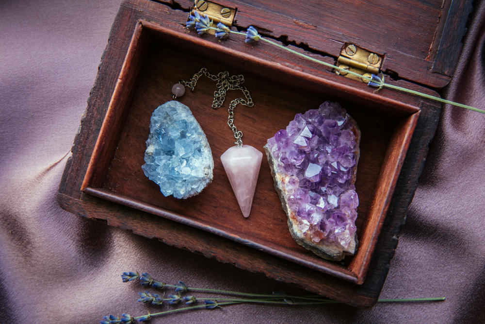 Witch tools inside beautiful old wood box. Rose quartz pendulum, natural amethyst and celestite crystal clusters.