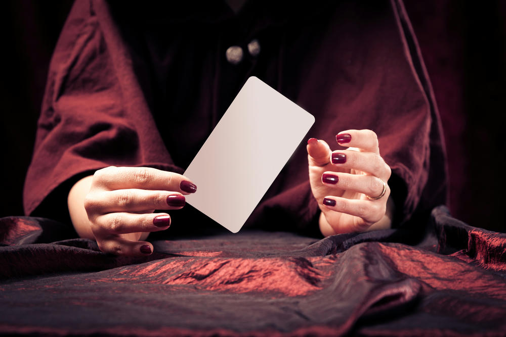 Fortune teller's hands in dark shades of red