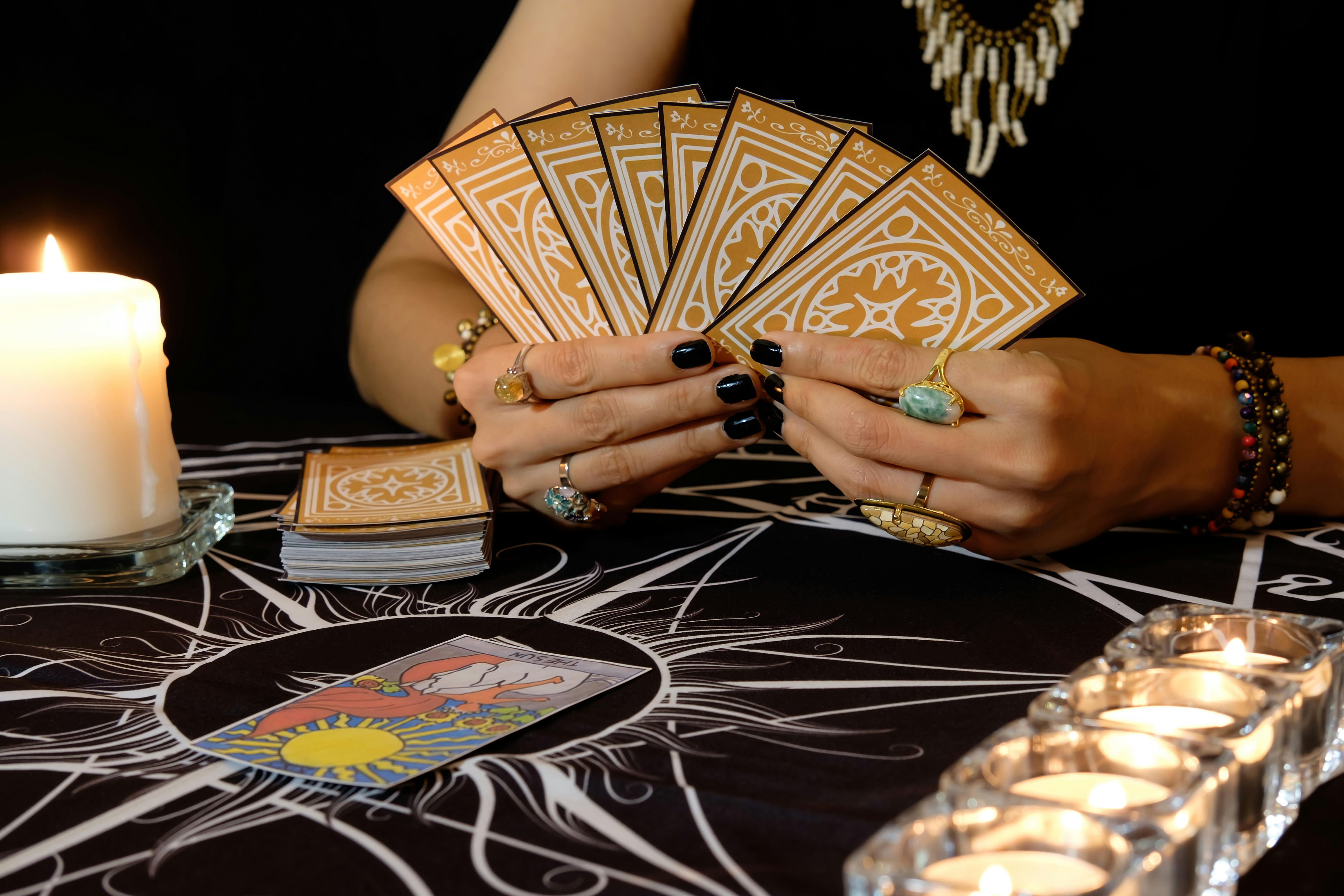 A woman holding a hand of tarot cards