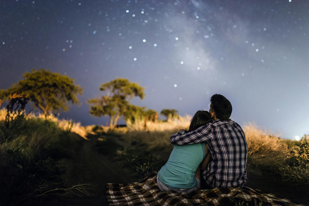couple hugging looking at the stars