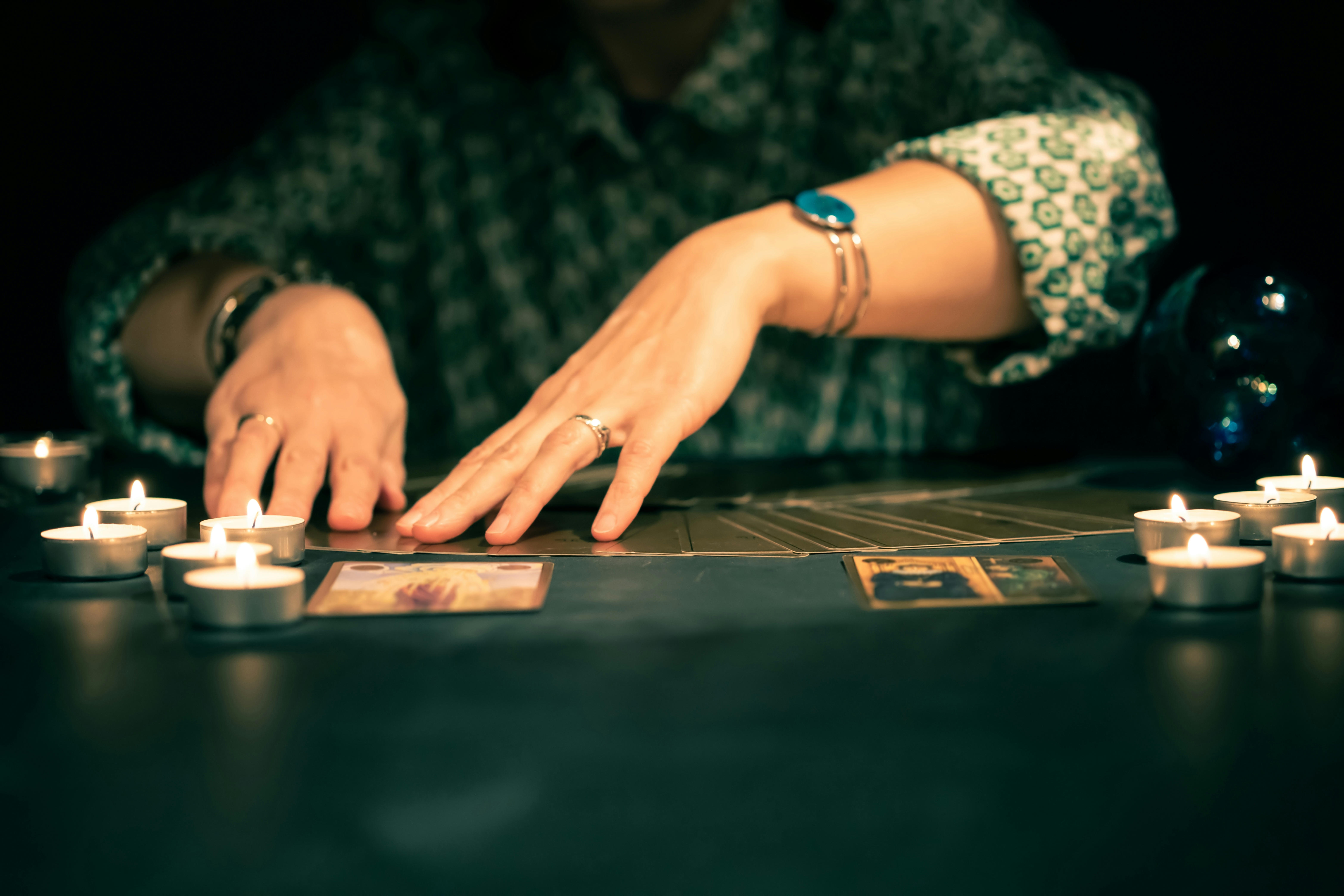 The hands of a psychic during a tarot reading