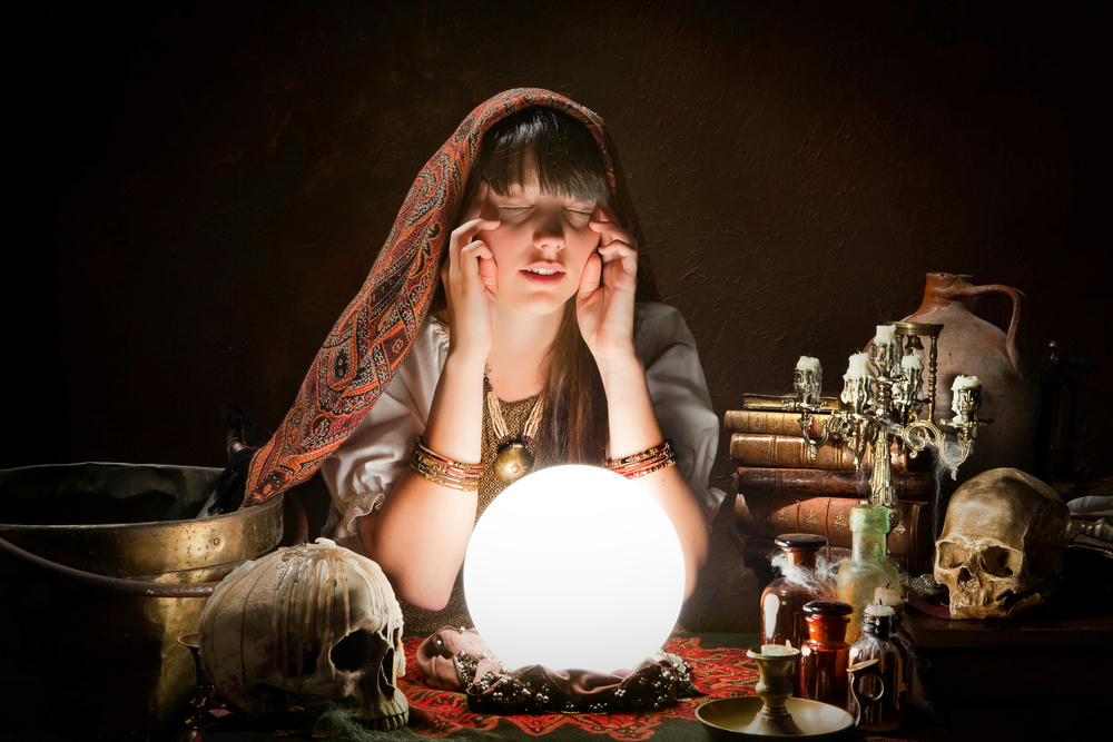 Women finger around her temp predicting the futrue with a crystal ball 